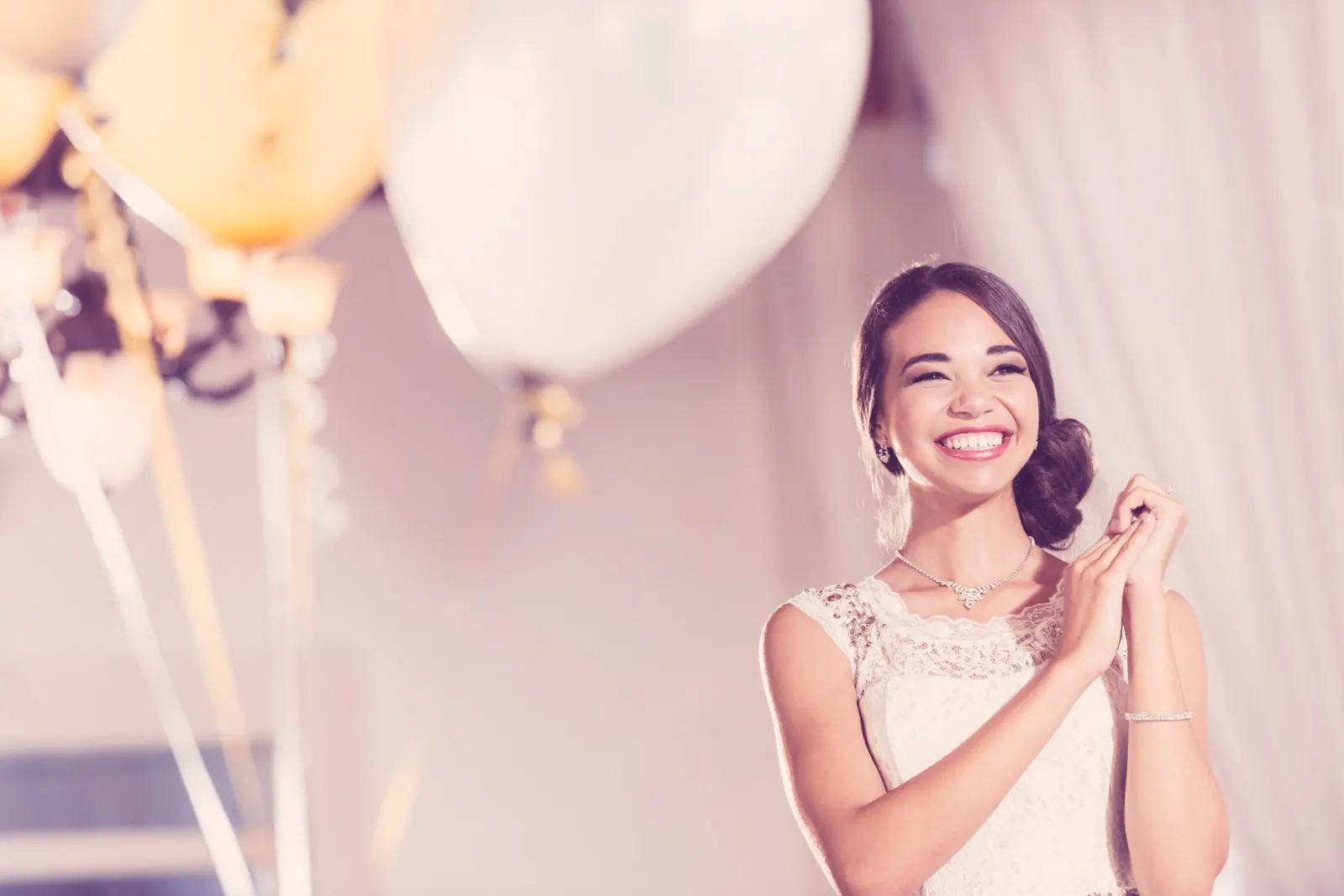 Gold and white balloons set up for a birthday party